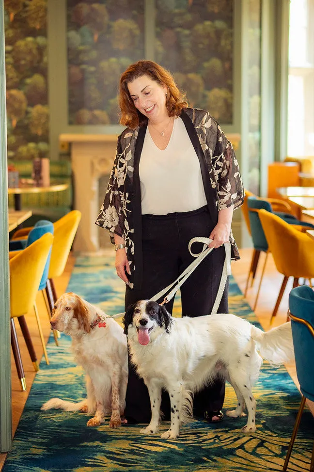 Ann from The Gilded Lead taking care of two dogs during the wedding ceremony